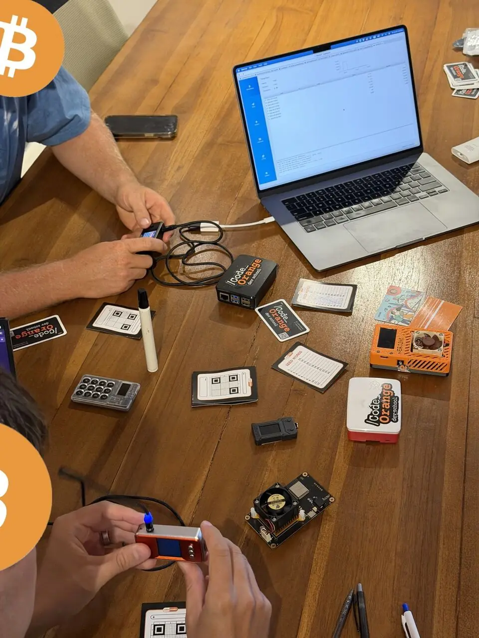 Bitcoin hardware tools and laptops on a workshop table